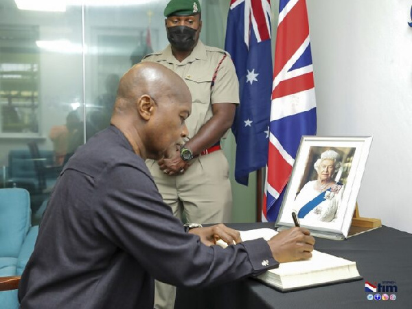 Stephen Ntim signing the book of condolence