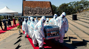 Pallbearers carry the coffin of late Zimbabwe's agriculture minister Perrance Shiri at his funeral