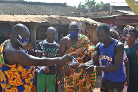 Awulae Attibrukusu III sharing nose mask to people within his traditional area