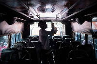 A staff member of Matatu sprays disinfectant inside a minibus as a preventative measure of coronavir