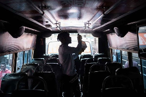 A staff member of Matatu sprays disinfectant inside a minibus as a preventative measure of coronavir