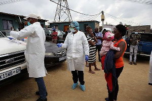 Health officials in South Africa prepare to do a Covid-19 swab test,  PHILL MAGAKOE | AFP