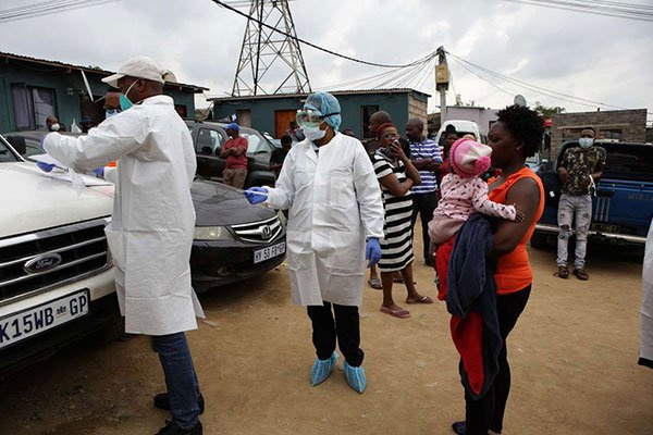 Health officials in South Africa prepare to do a Covid-19 swab test,  PHILL MAGAKOE | AFP