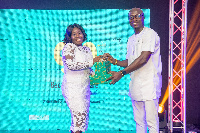 CEO Francis Gota (right) hands an award to a deserving staff member