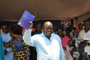 File photo of Nana Akufo-Addo holding NPP manifesto.