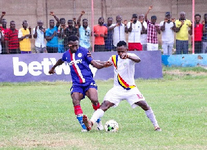 Liberty's Michael Amofa battles for the ball with Joseph Esso