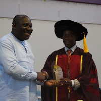 Hon. Vincent Sowah Odotei [L], receiving the award for Nenyi George Andah