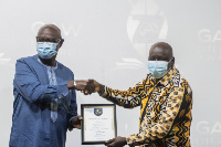 Alfred Asumadu (R) presenting the award to Daniel Owusu-Koranteng (L)