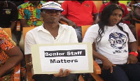 A UCC senior staff holding a placard