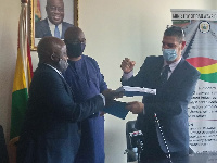 Joe Ghartey (middle), Richard Diegong Dombo (left) and Mr Nadav Simhoni (right) exchanging contract