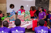 The executives of Y.A.W.S educating some female students on how to use sanitary pads