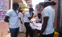 Albert Ankomah, regional FDA Head, interacting with people at the lorry station