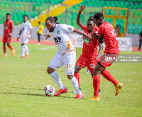 Kotoko players try to dispossess an Aduana player