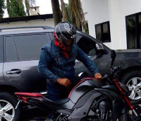 President Mahama gets ready to ride on his motorbike.