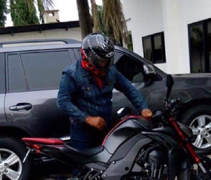 President Mahama gets ready to ride on his motorbike.