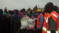 NADMO executive presenting the items to some of the victims