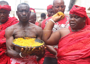 Ga Mashie sprinkling the traditional food; 