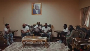 Screenshot of Meek Mill (third left) surrounded by his team in the music video