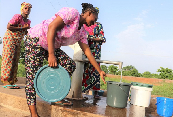 UNDP GH Nurse, Alima fetching water