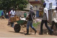 A man pushing a wheelbarrow