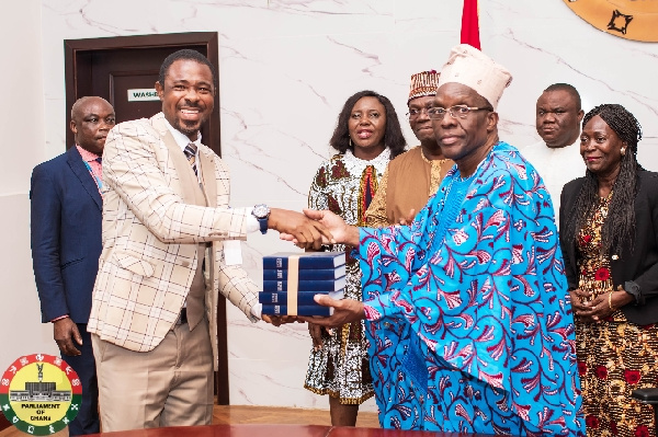 Speaker Bagbin (right) receiving a donation of the Bibles