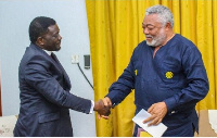 Bishop Charles Agyinasare (L) in a handshake with the late former president Jerry John Rawlings (R)