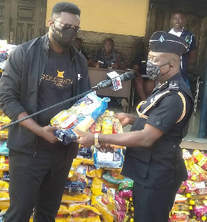 Dr. Sledge Duodu handing over the items