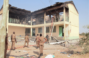 Personnel of the Ghana National Fire Service dousing the fire