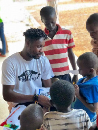 The striker was accompanied by friends and family to donate items such as Rice,Tuna,drinks and books