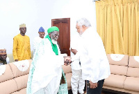 Former President Rawlings in a handshake with the national Chief Imam