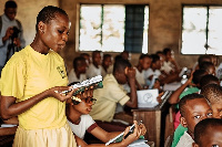 A student reading a book during a students' gathering