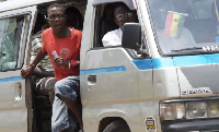 A bus conductor shouting for passengers (file photo)