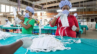 Factory workers check personal protective equipment for COVID-19 frontline health workers