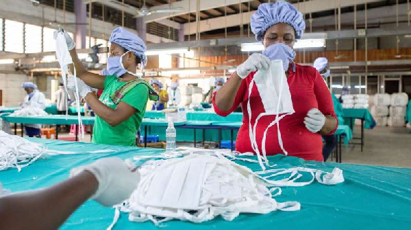 Factory workers check personal protective equipment for COVID-19 frontline health workers