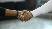 Individuals shaking hands.