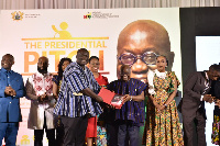 Richard Abbey presenting a copy to President Akufo-Addo