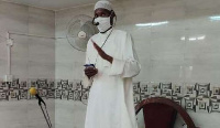 An Imam wearing nose mask