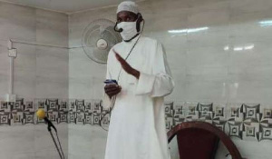 An Imam wearing nose mask