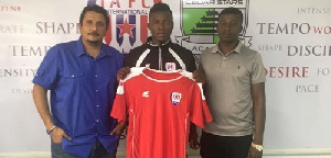 Samuel Armah (M) displays his jersey