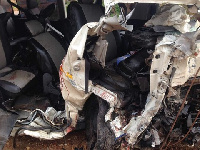 A mini bus rammed into a container that had fallen off a truck