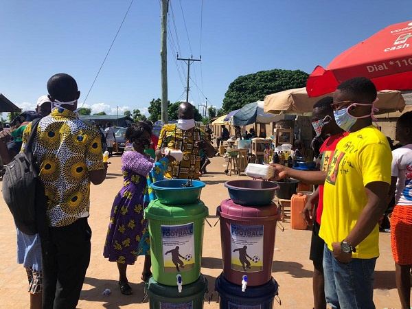 Officials of Keta Sunset presenting the items to the traders