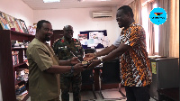 Dr. Vladimir Antwi-Danso receiving his plaque from Ekow Blankson of ADPU GH