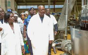 President Mahama with other in a factory(file photo)