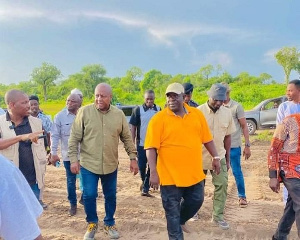 Former President, John Dramani Mahama with the people visiting the land