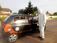 A health official screening a passenger