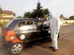 A health official screening a passenger