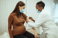 A pregnant woman receiving a jab