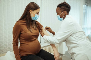 A pregnant woman receiving a jab