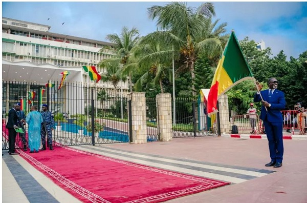 A man holds a Senegalese flag outside the National Assembly in Dakar