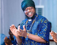 Blakk Rasta clothe in his wax print with a clerical